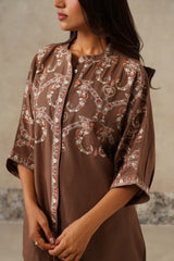 Close up of embroidery of paisley and florals in brown linen set