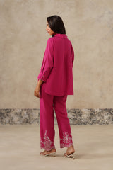 Woman in fuchsia co-ord set, back profile
