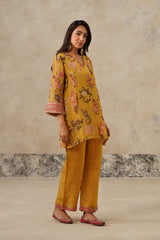 Woman wearing yellow floral printed co-ord set with dupatta, side angle