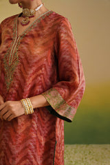 close up kurta Woman wearing rust printed farshi salwar set with embroidered neckline and dupatta