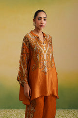 Woman in rust paisley printed kurta set, front profile