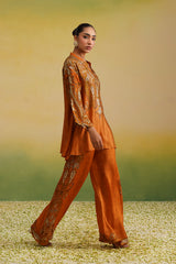 Rust co-ord set styled with wide-leg paisley printed pants
