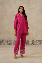 Woman wearing hot pink collared co-ord set with cutwork embroidered pants
