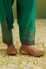 Detail of embroidered ankle border on emerald green pants